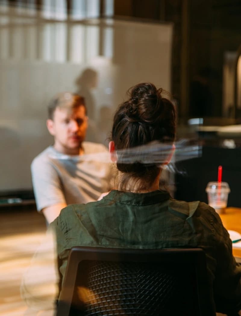 A corporate trainer leading an onboarding session with a small group in a meeting room